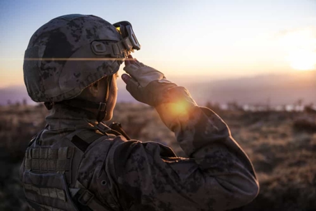 Military member solutes toward the sunrise